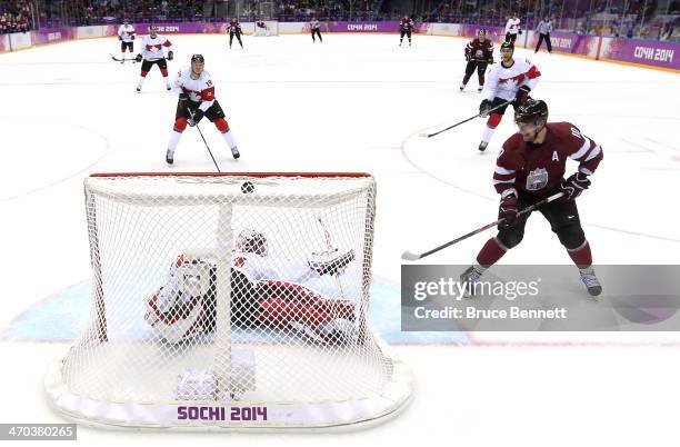 Lauris Darzins of Latvia scores a goal against Carey Price of Canada in the first period during the Men's Ice Hockey Quarterfinal Playoff on Day 12...