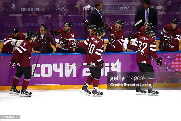 Lauris Darzins of Latvia celebrates with the bench after scoring a first-period goal against Canada during the Men's Ice Hockey Quarterfinal Playoff...