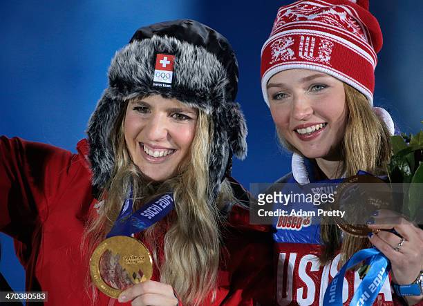 Gold medalist Patrizia Kummer of Switzerland and bronze medalist Alena Zavarzina of Russia celebrate on the podium during the medal ceremony for the...