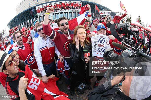 Fans surround a CBC TV broadcaster prior to the start of a playoff game between the Ottawa Senators and the Montreal Canadiens during Game Three of...