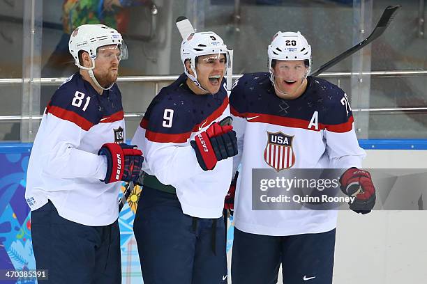 Zach Parise of the United States celebrates with teammates Phil Kessel of the United States and Ryan Suter of the United States after scoring his...