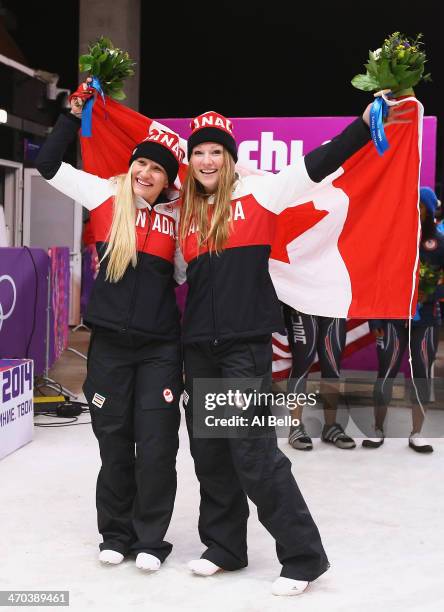 Kaillie Humphries and Heather Moyse of Canada team 1 celebrate during the flower ceremony after winning the gold medal during the Women's Bobsleigh...