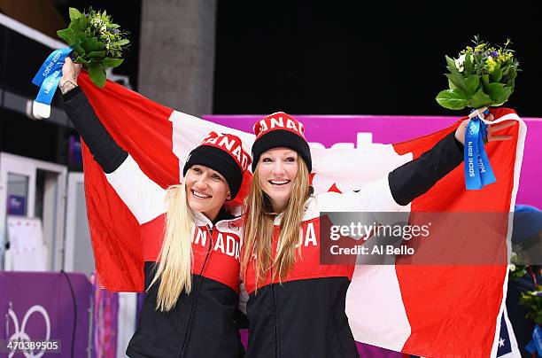 Kaillie Humphries and Heather Moyse of Canada team 1 celebrate during the flower ceremony after winning the gold medal during the Women's Bobsleigh...