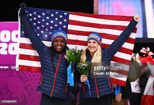 Bronze medallists Jamie Greubel and Aja Evans of the United States team 2 pose during the flower ceremony during the Women's Bobsleigh on Day 12 of...