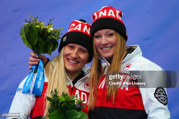 Kaillie Humphries and Heather Moyse of Canada team 1 celebrate during the flower ceremony after winning the gold medal during the Women's Bobsleigh...