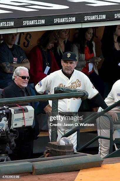 Brian Sabean of the San Francisco Giants and manager Bruce Bochy stand in the dugout during the 2014 World Series ring ceremony before the game...