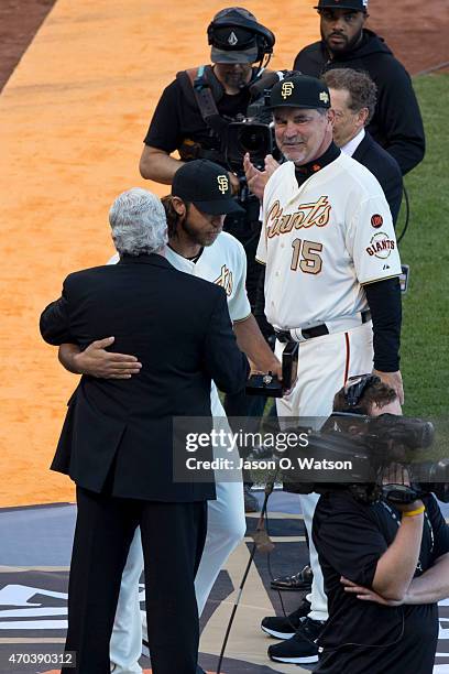 Madison Bumgarner of the San Francisco Giants hugs Brian Sabean during the 2014 World Series ring ceremony before the game against the Arizona...