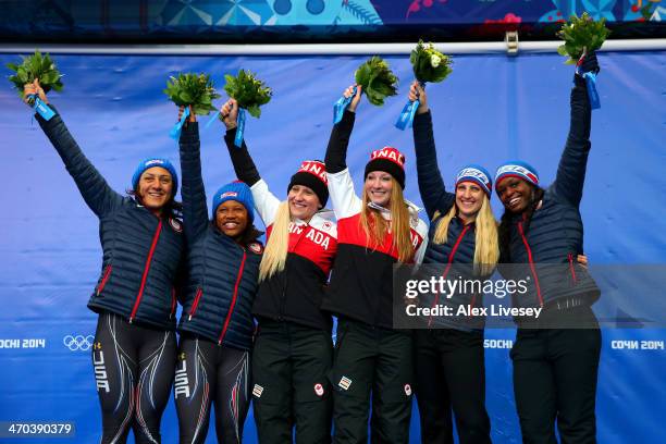 Gold medallists Kaillie Humphries and Heather Moyse of Canada team 1 pose on the podium with silver medallists Elana Meyers and Lauryn Williams of...