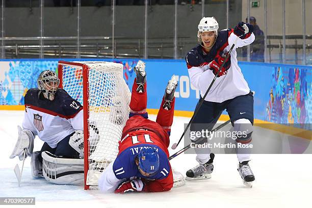 Martin Hanzal of the Czech Republic falls to the ice against John Carlson of the United States during the Men's Ice Hockey Quarterfinal Playoff on...