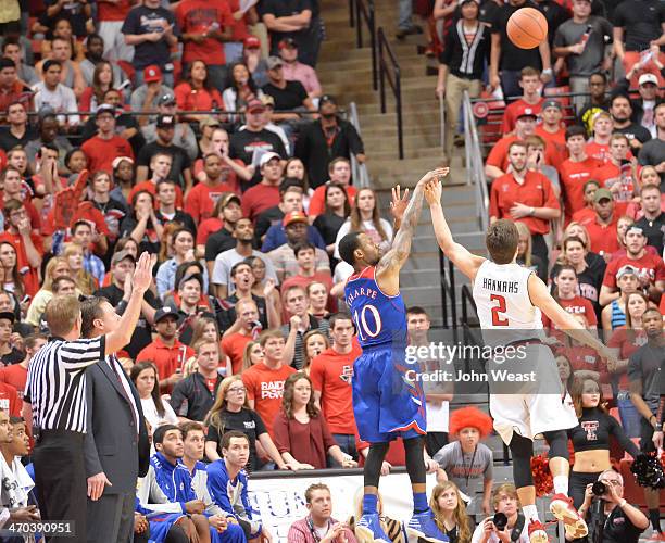 ZLUBBOCK, TX Naadir Tharpe of the Kansas Jayhawks shoots the ball over Dusty Hannahs of the Texas Tech Red Raiders during game action on February 18,...