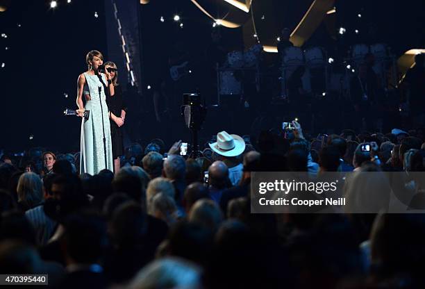 Honoree Taylor Swift accepts the 50th Anniversary Milestone Award from Andrea Swift onstage during the 50th Academy Of Country Music Awards at AT&T...