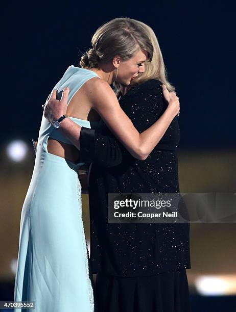 Honoree Taylor Swift accepts the Milestone Award from Andrea Swift onstage during the 50th Academy Of Country Music Awards at AT&T Stadium on April...