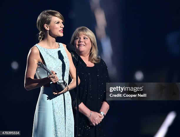 Honoree Taylor Swift accepts the Milestone Award from Andrea Swift onstage during the 50th Academy Of Country Music Awards at AT&T Stadium on April...