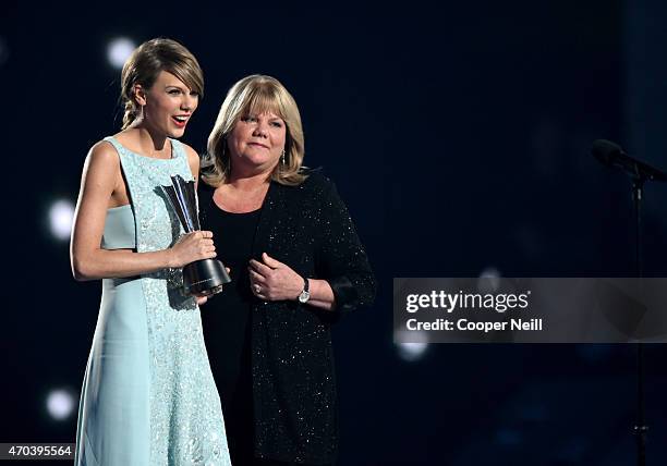 Honoree Taylor Swift accepts the Milestone Award from Andrea Swift onstage during the 50th Academy Of Country Music Awards at AT&T Stadium on April...