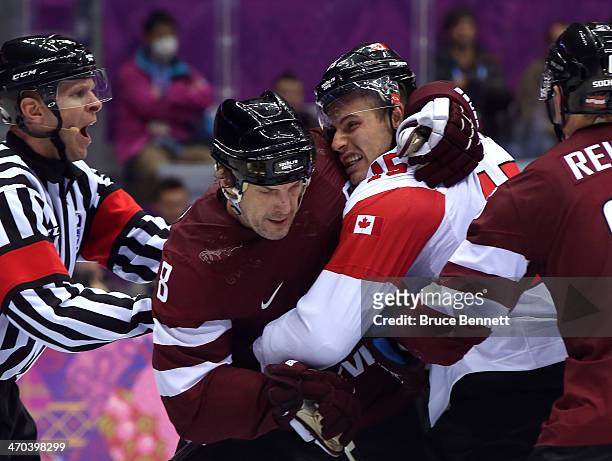 Sandis Ozolins of Latvia and Ryan Getzlaf of Canada shove each other during the Men's Ice Hockey Quarterfinal Playoff on Day 12 of the 2014 Sochi...