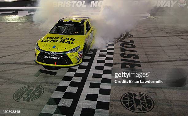 Matt Kenseth, driver of the Dollar General Toyota, celebrates with a burnout after winning the NASCAR Sprint Cup Series Food City 500 at Bristol...