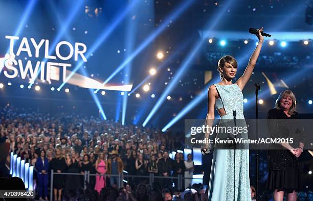 Honoree Taylor Swift accepts the 50th Anniversary Milestone Award from Andrea Swift onstage during the 50th Academy of Country Music Awards at AT&T...