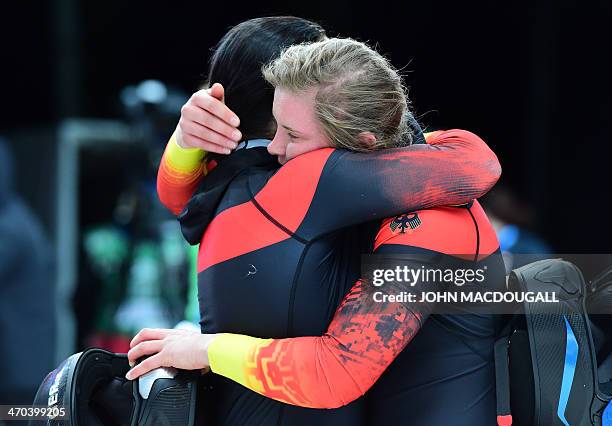 Germany-3 two-woman bobsleigh pilot Anja Schneiderheinze and brakewoman Stephanie Schneider celebrate during the Women's Bobsleigh Heat 4 and final...