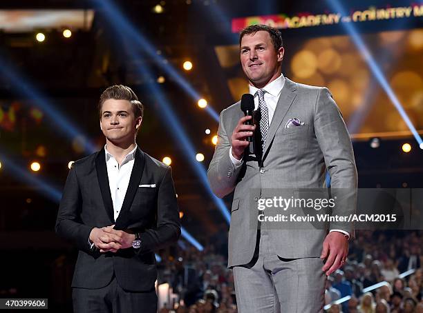 Recording artist Hunter Hayes and NFL player Jason Witten speak onstage during the 50th Academy of Country Music Awards at AT&T Stadium on April 19,...