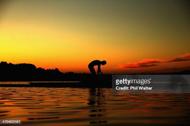 Rower launches his boat before an early morning training session during the Bankstream New Zealand Rowing Championships at Lake Karapiro on February...