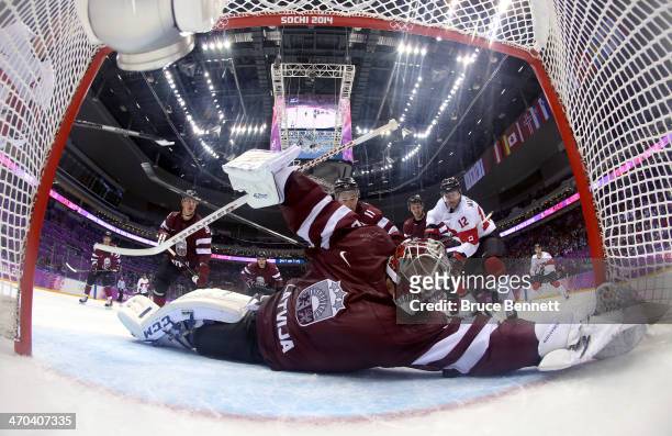 Kristers Gudlevskis of Latvia makes a save during the third period of the Men's Ice Hockey Quarterfinal Playoff on Day 12 of the 2014 Sochi Winter...