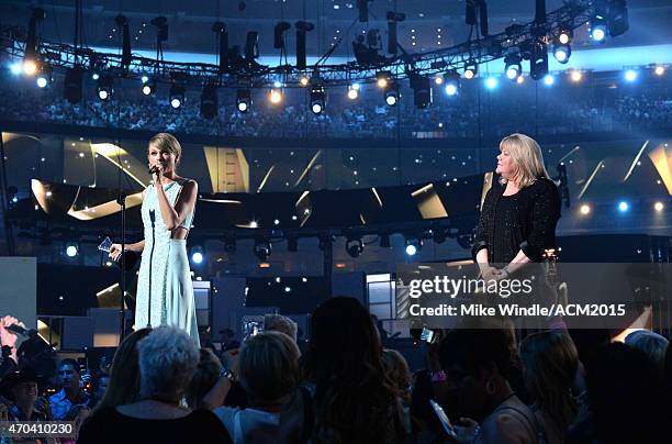 Honoree Taylor Swift accepts the Milestone Award from Andrea Swift onstage during the 50th Academy Of Country Music Awards at AT&T Stadium on April...