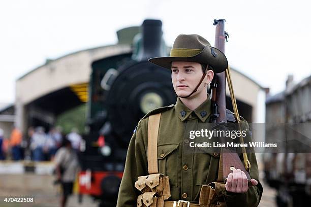 Ethan Moller of the '9th Battalion AIF Living History Unit' from Rockhampton stands alongside the ANZAC Troop Train on April 20, 2015 in Winton,...