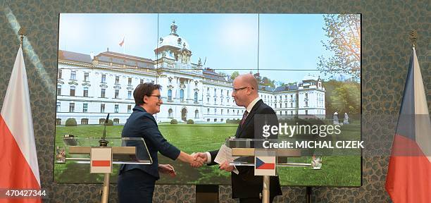 Czech Prime Minister Bohuslav Sobotka and his Polish counterpart Ewa Kopacz shake hands after addressing a joint press conference on April 20, 2015...