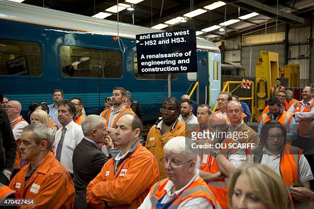 Workers listen in front of an autocue machine as British Prime Minister and leader of the Conservative Party, David Cameron and Conservative British...