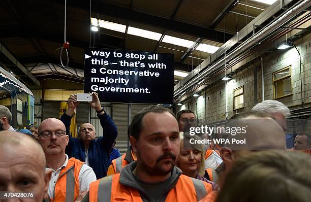 An autocue screen is seen behind Rail workers as Prime Minister David Cameron and Chancellor of the Exchequer George Osborne address guests during a...