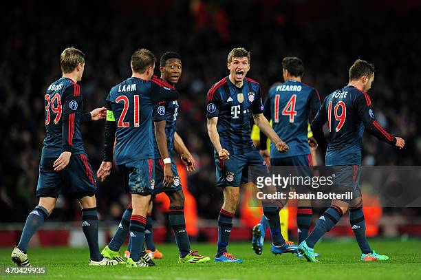 Thomas Mueller of Bayern Muenchen celebrates with his team mates after scoring the second goal during the UEFA Champions League Round of 16 first leg...