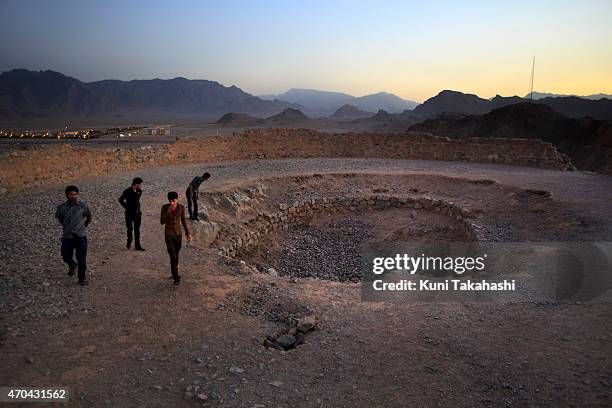 Local visitors walk around the top of Tower of Silence to watch sunset in Yazd, Iran on June 13, 2014. Zoroastrian conducted sky burial at the tower...