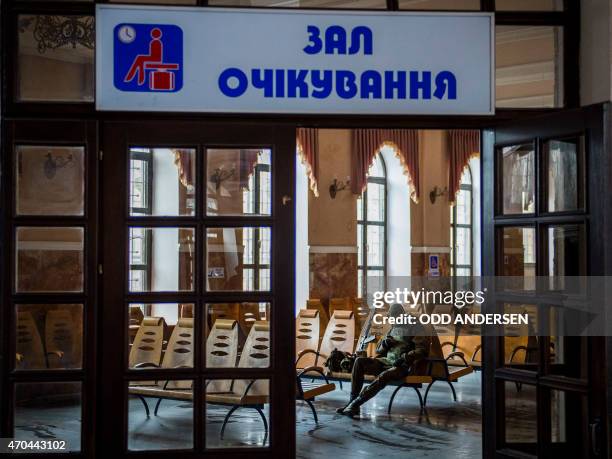 Pro-Russian separatist sits in the waiting room of the train station in Debaltseve on April 20, 2015 in the self-proclaimed Donetsk People's Republic...