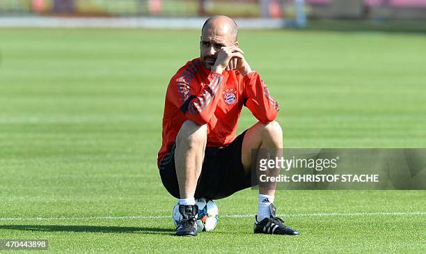 Bayern Munich's Spanish headcoach Pep Guardiola sits on the ball during a training session in Munich, southern Germany on April 20 a day ahead of the...