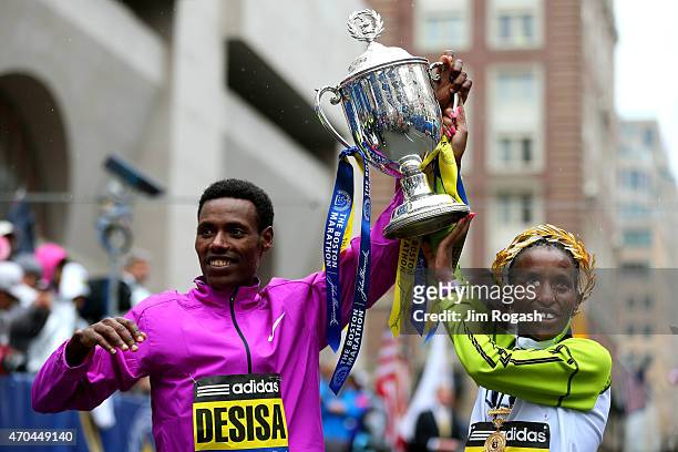 Lelisa Desisa of Ethiopa and Caroline Rotich of Kenya celebrate after winning the 119th Boston Marathon on April 20, 2015 in Boston, Massachusetts.