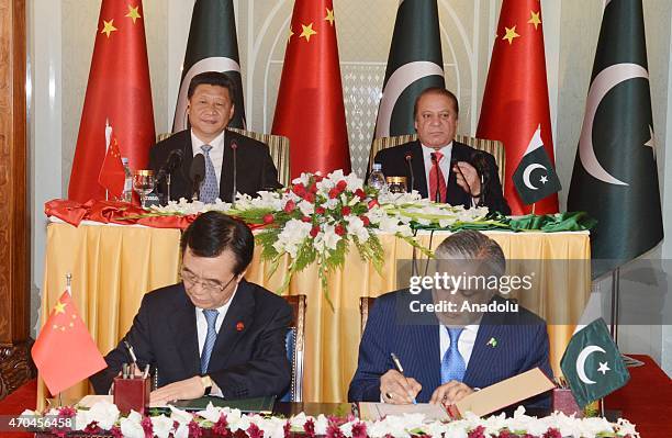 In this handout photograph released by the Press Information Department shows Chinese President Xi Jinping and Pakistan's Prime Minister Nawaz Sharif...