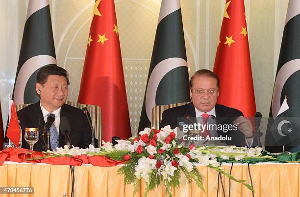 Handout picture released by the Press Information Department shows China President Xi Jinping sits with Pakistani Prime Minister Nawaz Sharif during...