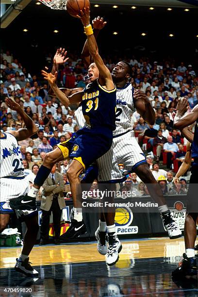Reggie Miller of the Indiana Pacers shoots the ball against Shaquille O'Neal of the Orlando Magic during game 1 of the Eastern Conference Finals on...
