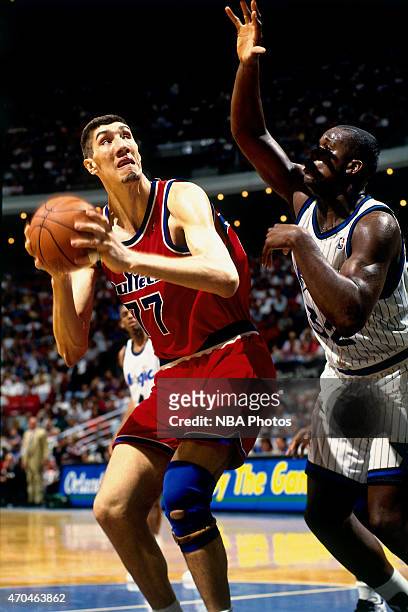 Gheorghe Muresan of the Washington Bullets handles the ball against the Orlando Magic on April 17, 1995 at the Amway Arena in Orlando, Florida. NOTE...