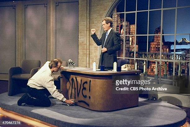 Bill Murray spray paints Dave's desk on the first taping of the Late Show with David Letterman, August 30, 1993 on the CBS Television Network. This...