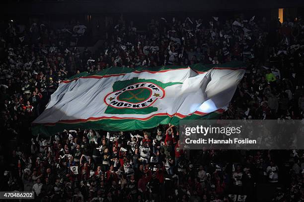 Fans hold up a flag before Game Three between the Minnesota Wild and the St. Louis Blues of the Western Conference Quarterfinals during the 2015 NHL...