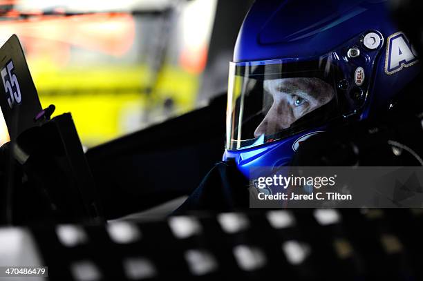 Brian Vickers, driver of the Aaron's Dream Machine Toyota, sits in his car during practice for the NASCAR Sprint Cup Series Daytona 500 at Daytona...