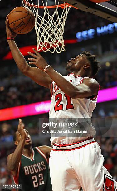 Jimmy Butler of the Chicago Bulls goes up for a shot over Khris Middleton of the Milwaukee Bucks on his way to a game-high 31 points during the first...