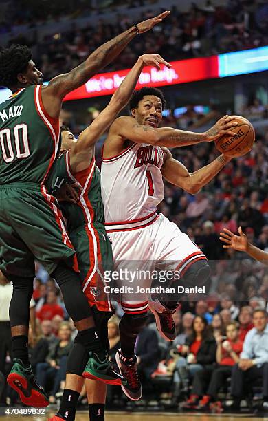 Derrick Rose of the Chicago Bulls drives to the basket pagainst O.J. Mayo and Michael Carter-Williams of the Milwaukee Bucks during the first round...