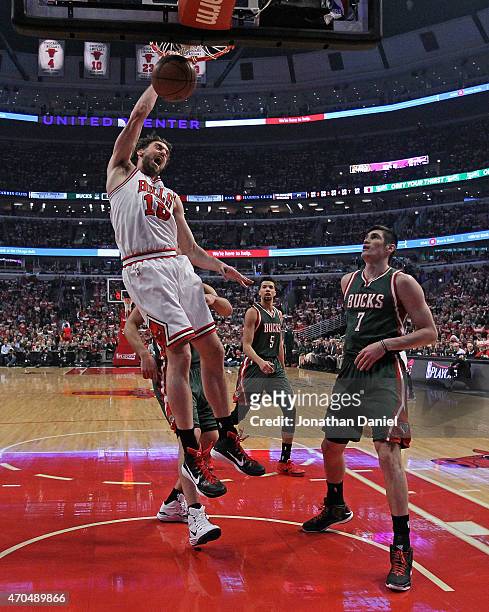 Pau Gasol of the Chicago Bulls dunks over Ersan Ilyasova of the Milwaukee Bucks during the first round of the 2015 NBA Playoffs at the United Center...