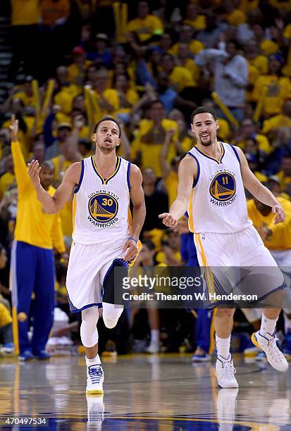 Stephen Curry, and Klay Thompson of the Golden State Warriors reacts after Curry hit a jump shot against the New Orleans Pelicans in the fourth...