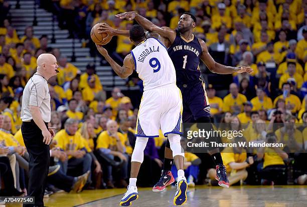 Tyreke Evans of the New Orleans Pelicans defends the pass attempt of Andre Iguodala of the Golden State Warriors in the third quarter during the...