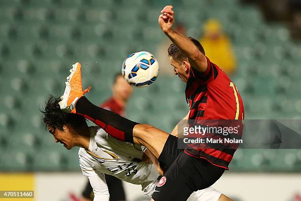 Mu Kanazaki of Kashima and Matthew Spiranovic of the Wanderers contest possession during the Asian Champions League match between the Western Sydney...
