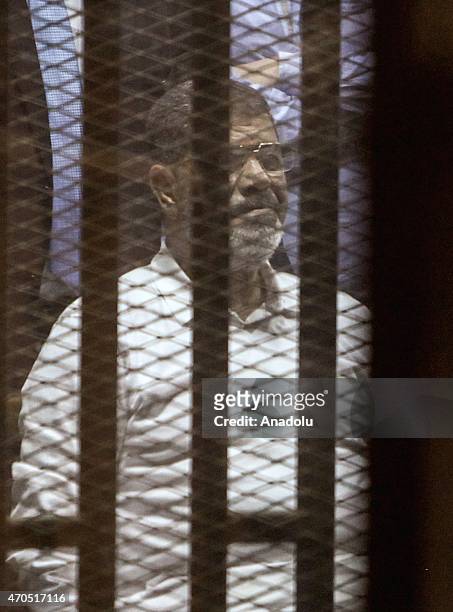 Egypt's former president Mohammed Morsi looks from behind dock bars during trial session, in Cairo, Egypt on 21 April 2015. An Egyptian court...