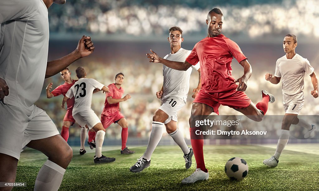 Soccer player kicking ball in stadium